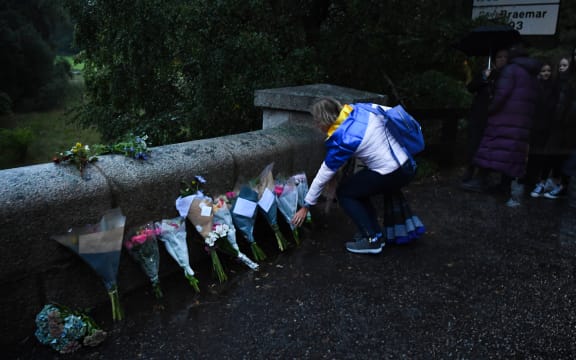 Members of the public leave floral tributes on the roadside outside the Balmoral Estate in Ballater, Scotland on September 9, 2022.