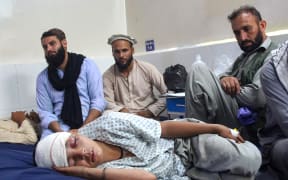 An injured Afghan boy (bottom) receives treatment at a hospital after an earthquake in Afghanistan's Jalalabad on September 1, 2025. Nine people died when a 6.0-magnitude earthquake and powerful aftershock rattled eastern Afghanistan, the provincial Nangarhar government said on September 1. (Photo by Aimal ZAHIR / AFP)