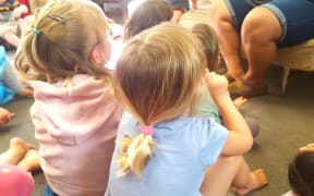 children sit on the mat at an early childhood centre