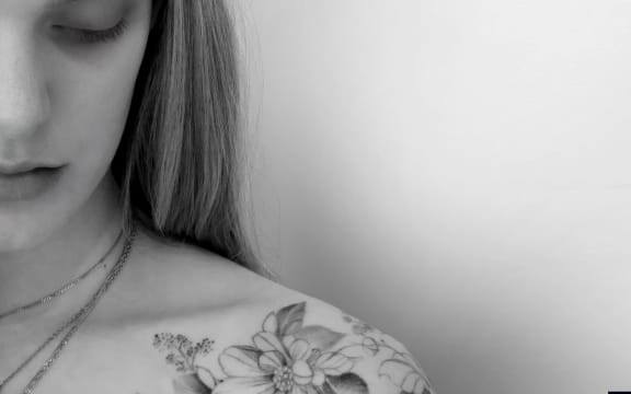 cover image of Guy Wishart's album 'Where the Water Runs Through': photo of a woman with a flower tattoo on shoulder.