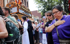 Clergy observe a moment of silence during the memorial service for Heather Heyer outside the Paramount Theater in Charlottesville, Virginia.