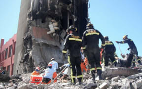 Rescue workers at the ruins of the CTV building in February 2011.