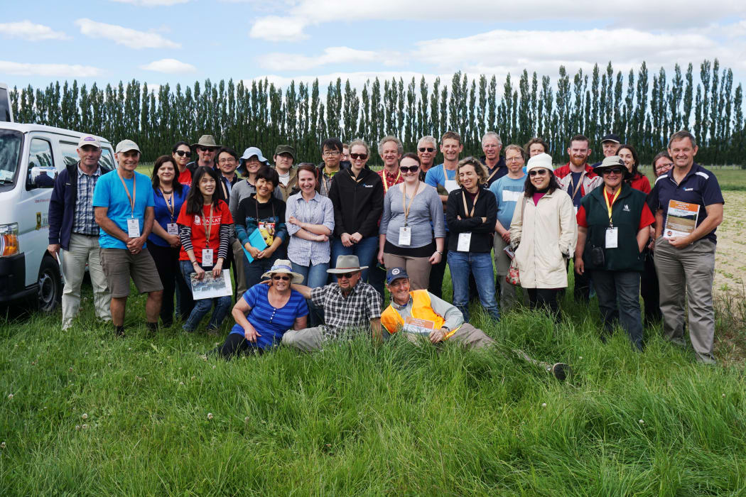 A group of soil scientists enjoying a field trip to explore volcanic soils. Dairy farmer Eric Smeith is pictured in the middle of the front row, and on the right is Waikato University soil scientist David Lowe (in high-visibility vest), who lead the trip.