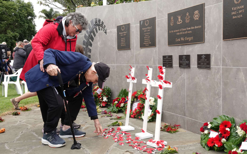 Korean War veteran Victor Peach, with healthcare assistant Amanda Miller, lays a poppy at Kerikeri’s memorial wall.