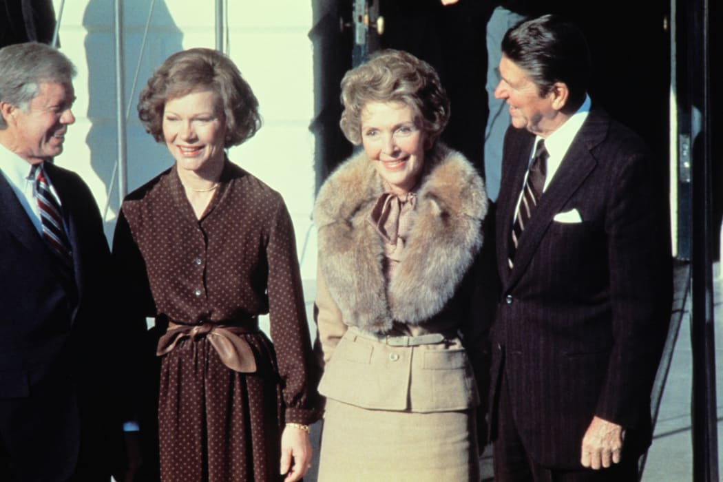 Jimmy Carter, left, Rosalynn Carter, second left, greet Ronald Reagan and his wife Nancy Reagan at the White House on 20 November 1980.