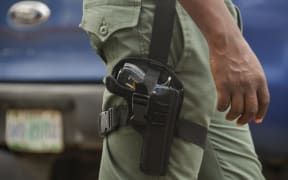 police officer on duty with Glock service revolver patrols during Stakeholders Engagement on Internal Security and Conflict Resolution across the country held in Lagos State