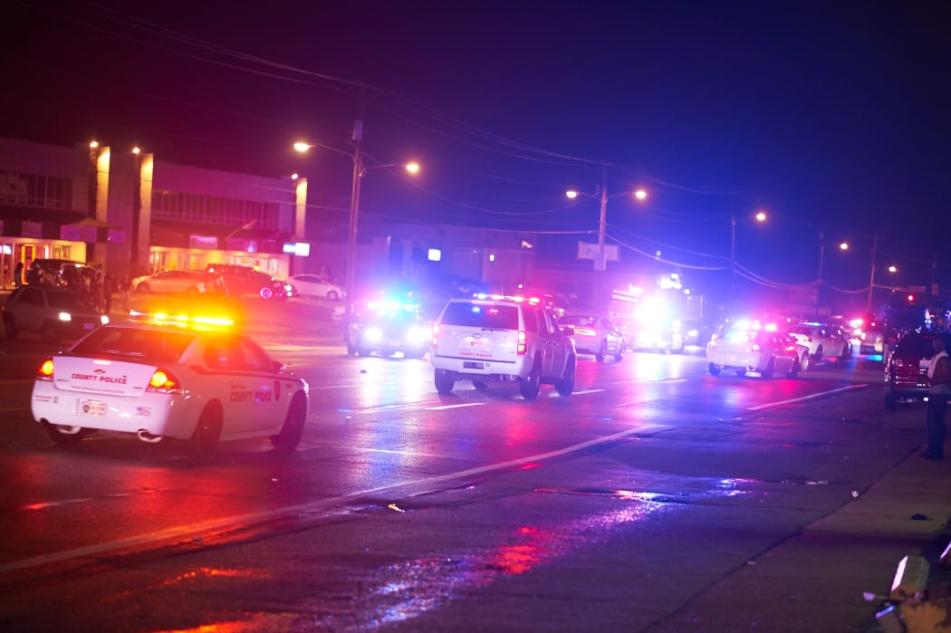 A St Louis County police officers respond after shots were fired during the protest march on 9 August.