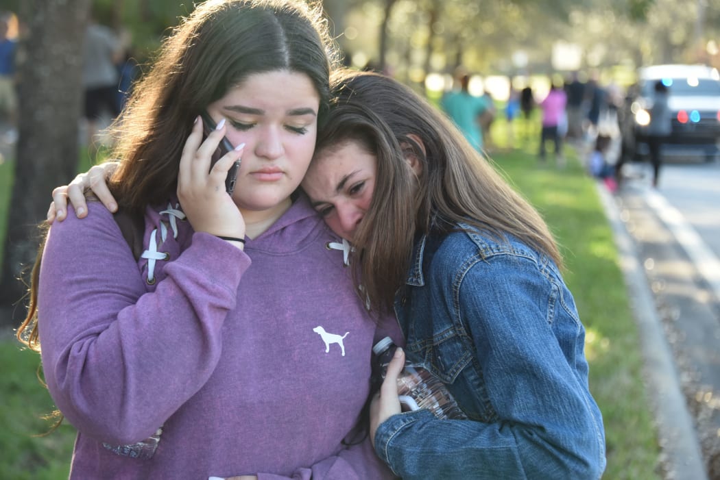 Students react following the shooting at Marjory Stoneman Douglas High School in Parkland, Florida.