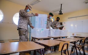 Soldiers stand guard at a polling station in the Gualberto Kong Fernandez Basic School in Vallenar, Chile, on November 20, 2021, on the eve of Chile's general elections.