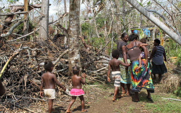 Shaline Nimal walks through what is left of the village of Rangorango on Efate island, Vanuatu.