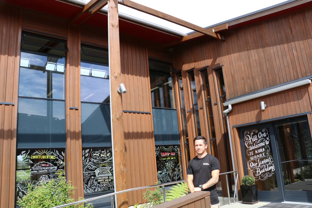 Maia Rurehe at the front entranceway of Te Kura Whare, Taneatua.