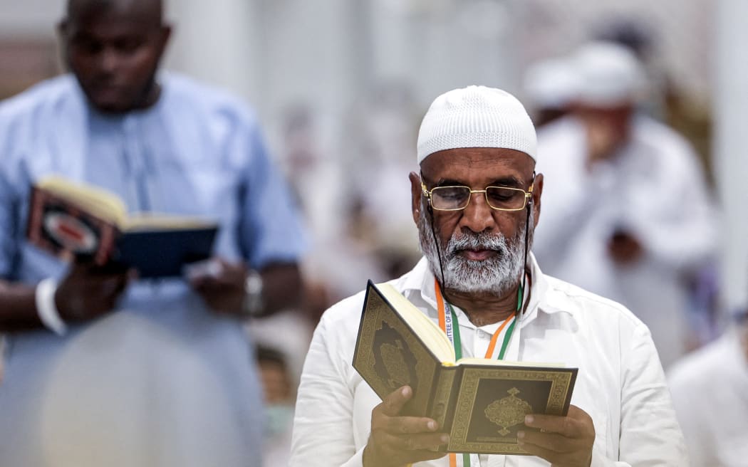 A man reads from the Koran, Islam's holy book, at the Grand Mosque in Saudi Arabia's holy city of Mecca on June 4, 2024. (Photo by Abdel Ghani BASHIR / AFP)