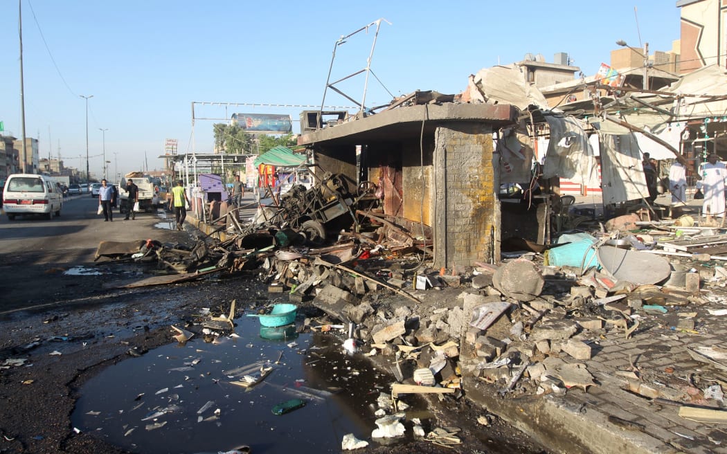 The aftermath of an explosion after a car bomb attack in the mostly Shia Sadr City district of Baghdad.