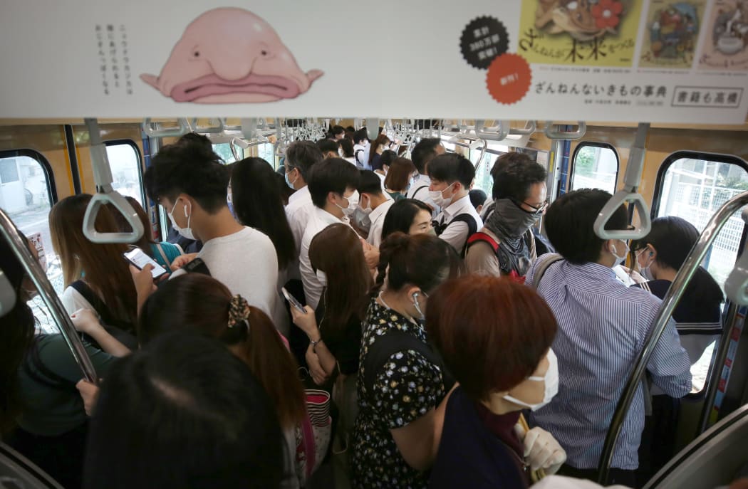 An inside of train is packed with passengers on a JR Line  during a rush hour in Ota Ward, Tokyo  on June 15, 2020,