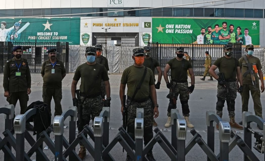 Policemen stand guard outside the Rawalpindi Cricket Stadium in Rawalpindi on September 17, 2021, after New Zealand postponed a series of one-day international (ODI) cricket matches against Pakistan over security concerns.