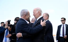 Israel Prime Minister Benjamin Netanyahu (L) greets US President Joe Biden upon his arrival at Tel Aviv's Ben Gurion airport on October 18, 2023, amid the ongoing battles between Israel and the Palestinian group Hamas. Biden landed in Israel on October 18, on a solidarity visit following Hamas attacks that have led to major Israeli reprisals. Thousands of people, both Israeli and Palestinians have died since October 7, 2023, after Palestinian Hamas militants based in the Gaza Strip, entered southern Israel in a surprise attack leading Israel to declare war on Hamas in Gaza on October 8. (Photo by Brendan SMIALOWSKI / AFP)