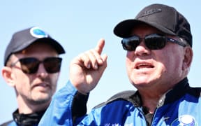 Star Trek actor William Shatner (R) speaks to media on the landing pad of Blue Origin's New Shepard as Planet Labs co-founder Chris Boshuizen looks on. The pair flew into space on October 13, 2021 near Van Horn, Texas.