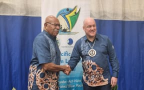 Fijian prime minister Sitiveni Rabuka shakes hands with Christopher Luxon.