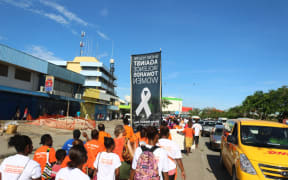 Solomon Islanders mark White Ribbon Day in Honiara on Friday 25th November, 2016. This year was the first time local businesses joined the march in support of ending violence against women.