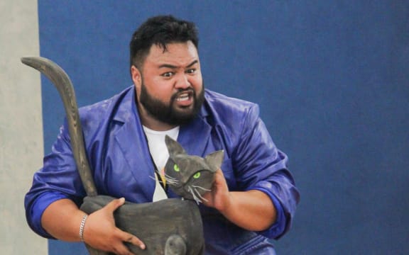 Ridge Ponini Opera in Schools, holding a stage prop cat.