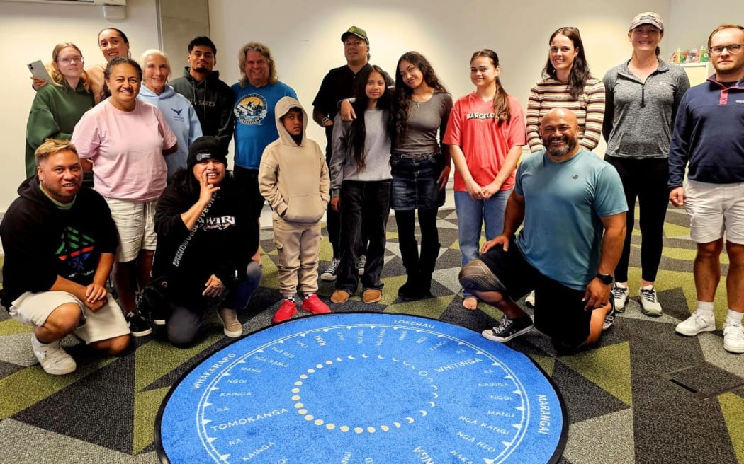 Participants in the Tagaloa Sailing Project around a navigation mat during a training session combining traditional Pacific voyaging knowledge and modern sailing skills.