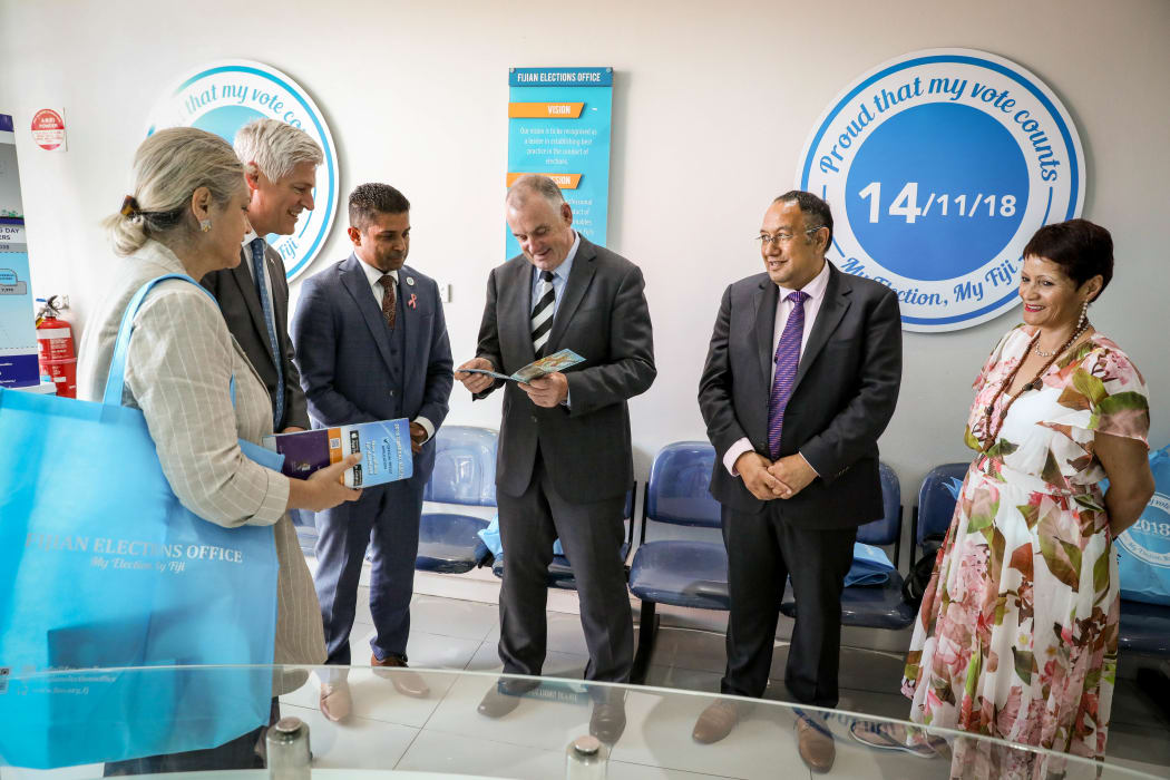 Fiji Supervisor of Elections Mohammed Saneem presents New Zealand Speaker Trevor Mallard with a gift