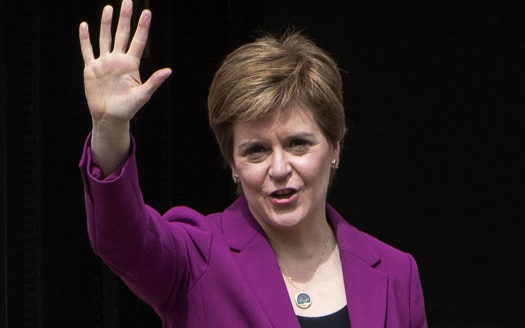 First Minister Nicola Sturgeon waves on the steps of her official residence  in Edinburgh following the SNP's victory in the Scottish parliament elections.