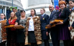 Leah Bell and Waimarama Anderson presenting their petition to parliamentarians
