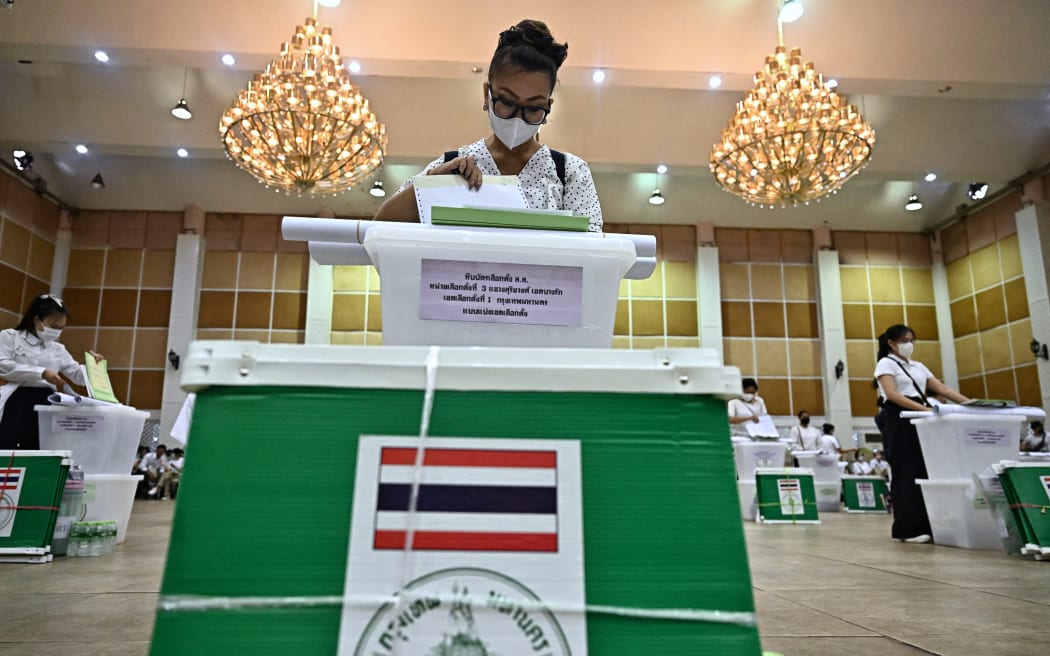 Election Commission volunteers inspect ballots and voting materials for distribution to polling booths in Bangkok on May 13, 2023, on the eve of the Thailand General election. (Photo by Lillian SUWANRUMPHA / AFP)