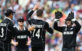 Mitchell Santner and wicketkeeper Tom Latham celebrate a wicket.
