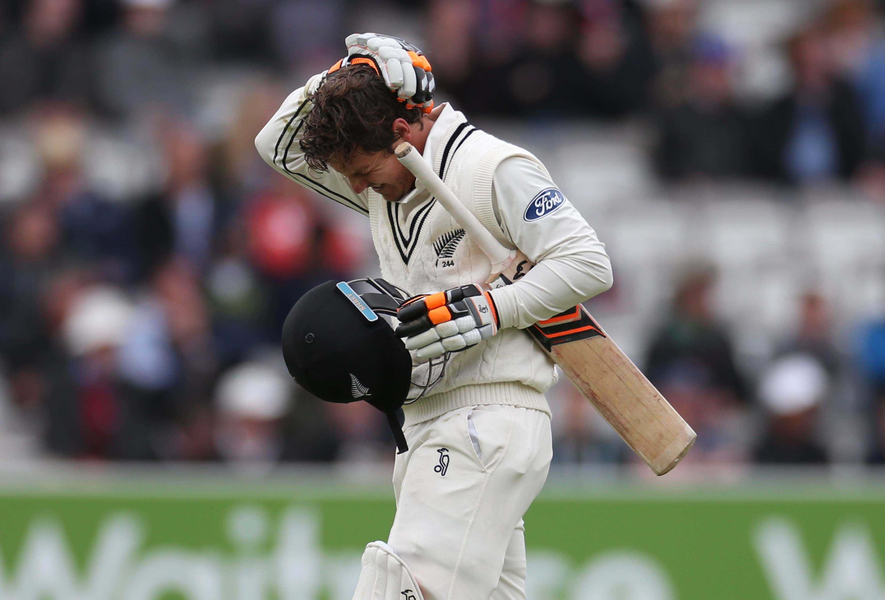 BJ Watling completes a run holding his head after being hit by a Mark Wood delivery during the first Investec Test Match between England and New Zealand at Lord's Cricket Ground, London.
