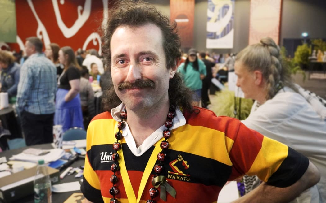 Early Childhood Education teacher Zane McCarthy stands smiling.