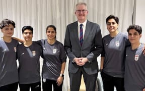 An undated and unplaced photo released by Australia's Department of Home Affairs shows Home Affairs minister Tony Burke (3/R) with five Iranian women football players who applied for asylum after competing in the Women's Asia Cup tournament being played in Australia. Australia has granted asylum to some of Iran's visiting women's football team over fears they faced persecution at home for not singing the national anthem before a match, Home Affairs Minister Tony Burke said on Tuesday. (Photo by HANDOUT / AUSTRALIAN DEPARTMENT OF HOME AFFAIRS / AFP) / ----EDITORS NOTE ----RESTRICTED TO EDITORIAL USE MANDATORY CREDIT " AFP PHOTO / DEPARTMENT OF HOME AFFAIRS" NO MARKETING NO ADVERTISING CAMPAIGNS - DISTRIBUTED AS A SERVICE TO CLIENTS
