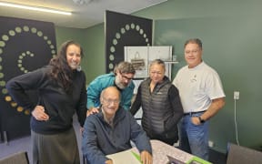 Turiroa chairman Daren King (seated) signing the Turiroa agreement, with directors (from left) Benita Tahuri, Irah Heyder, Tina Wilcox and Dean Whaanga