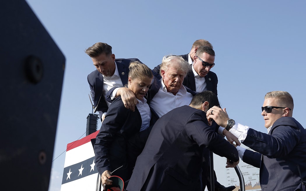 Trump is rushed offstage during a rally on 13 July, 2024 in Butler, Pennsylvania.