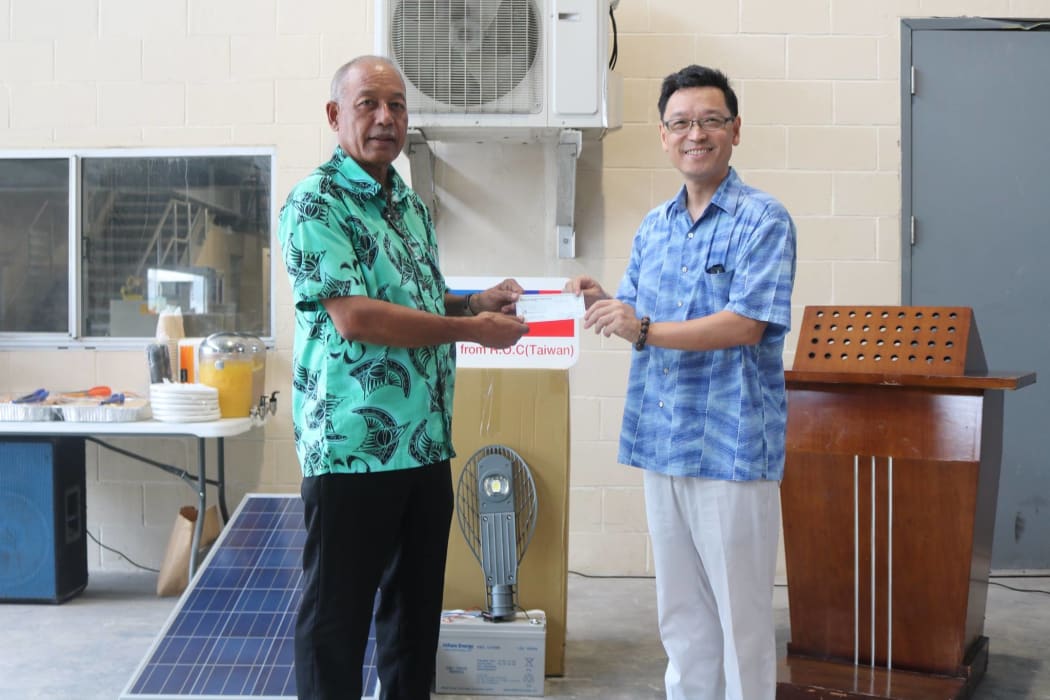 The Minister of Natural Resources and Commerce Dennis Momotaro (left) receives solar streetlight and funding donation from Taiwan's  Ambassador to the Marshall Islands, Daniel Tang.