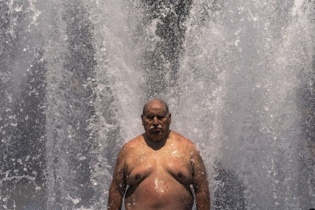 Pablo Miranda cools off in the Salmon Springs Fountain on June 27, 2021 in Portland, Oregon. Record breaking temperatures lingered over the Northwest during a historic heatwave this weekend.