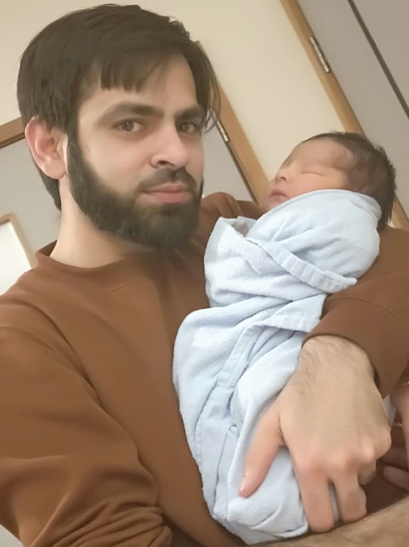 Syed Jahandad Ali holding son Mohammad Yousuf Ali.