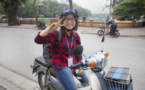 Girl on motorbike at Hoa Kiem Lake, Hanoi