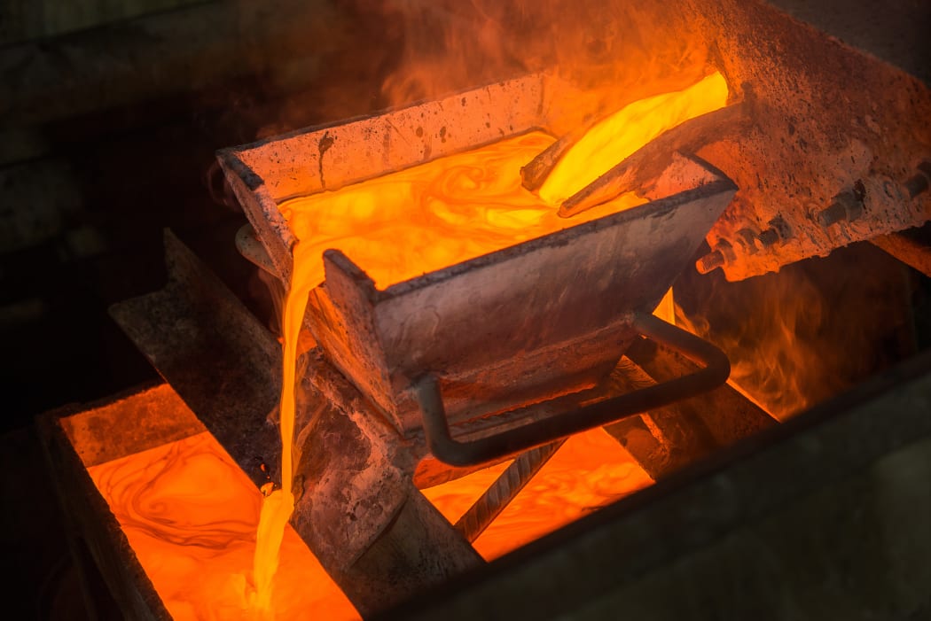 Casting gold at a factory. Gold mining.