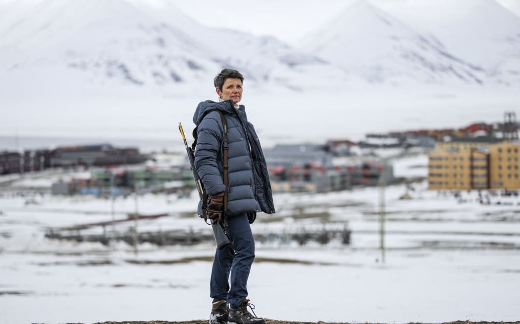 Siv Limstrand, the priest at Svalbard church, with her rifle over her shoulder, in Longyearbyen, Spitsbergen island, Svalbard Archipelago, northern Norway, on 6 May, 2022.