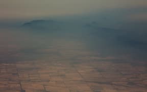Smoke and haze over mountains seen from an Australian air force aircraft assessing damage in the area from bushfires, in Cooma in New South Wales on 7 January, 2020.