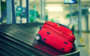 Luggage on airport carousel.