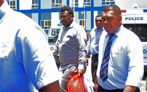 Accused Jale Aukerea (centre) makes his way to the Nadi Magistrates Court on 29 January 2013. Picture: