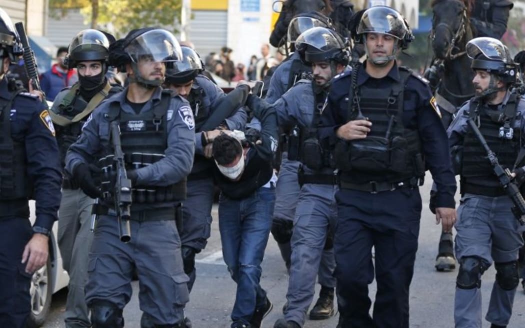 Israeli security forces detain a Palestinian protester in East Jerusalem.