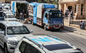 Workers unload humanitarian aid packages provided by the United Nations Children's Fund (UNICEF) and the World Food Programme (WFP) to residents of the predominantly Christian village of Qlayaa in southern Lebanon on October 15, 2024. Israel expanded operations in Lebanon nearly a year after Hezbollah began exchanging fire in support of its ally, Hamas, following the Palestinian group's deadly attack on Israel on October 7, 2023. (Photo by AFP)