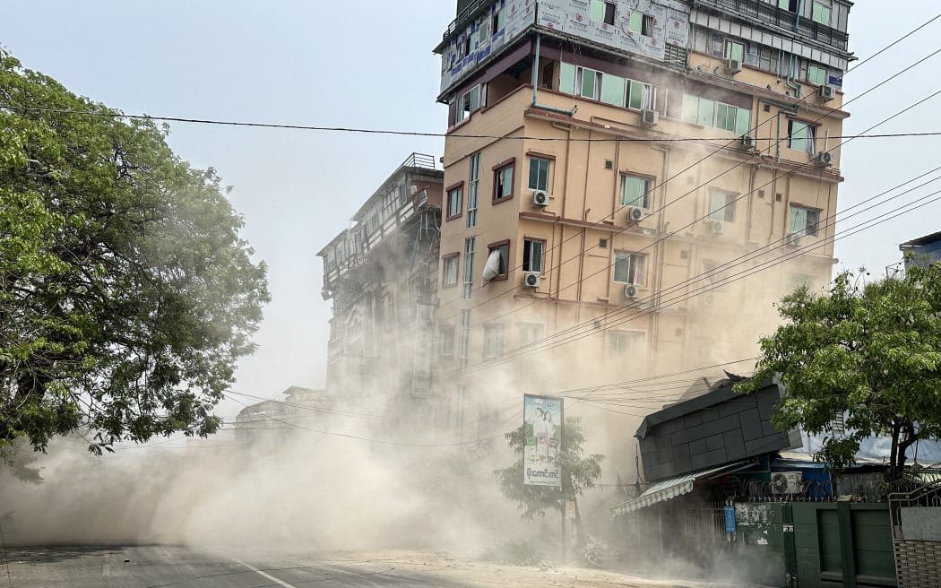 This photo shows a building collapsing in Mandalay on March 28, 2025, during an earthquake. A powerful earthquake killed more than 20 people across Myanmar and Thailand on March 28, toppling buildings and bridges and trapping over 80 workers in an under-construction skyscraper in Bangkok. (Photo by AFP)