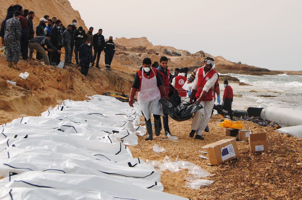 February 21, 2017 by the Al-Zawiyah Branch of the Libyan Red Crescent shows Libyan Red Crescent volunteers recovering the bodies of 74 migrants that washed ashore on February 20 near Zawiyah on Libya’s northern coast.