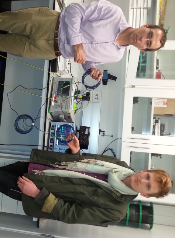 A photo of Neil Broderick and Patrick Bowen with the equipment that measures light in the optic fibres
