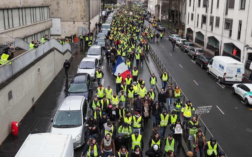 "Yellow vest" (gilet jaune) protestors march in the streets of Tours as they take part in a demonstration to protest against the rising costs of living